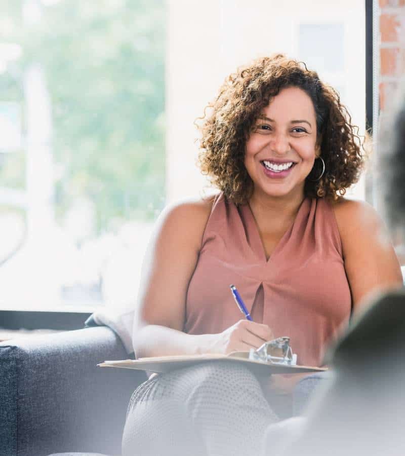 Therapist happily talking to client about art therapy in Chattanooga, TN.