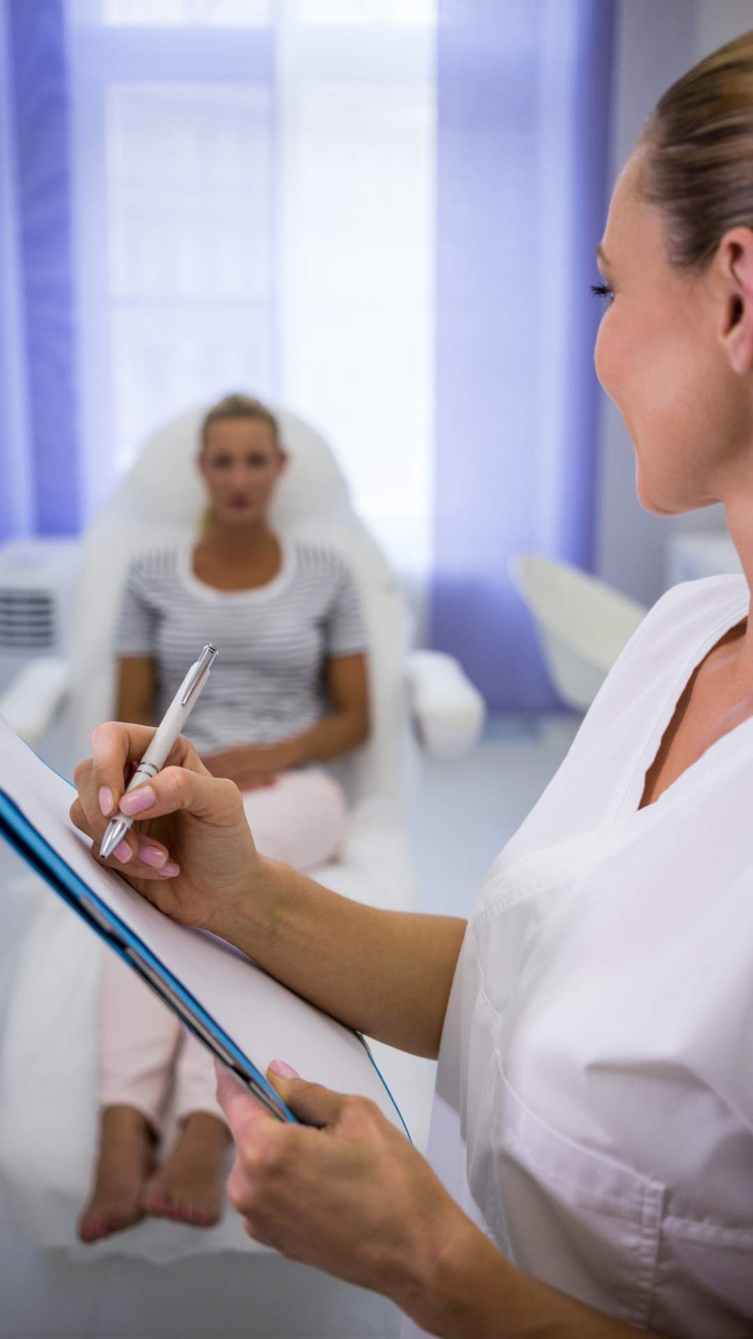 Biofeedback specialist getting female patient ready for biofeedback therapy in Chattanooga, TN.